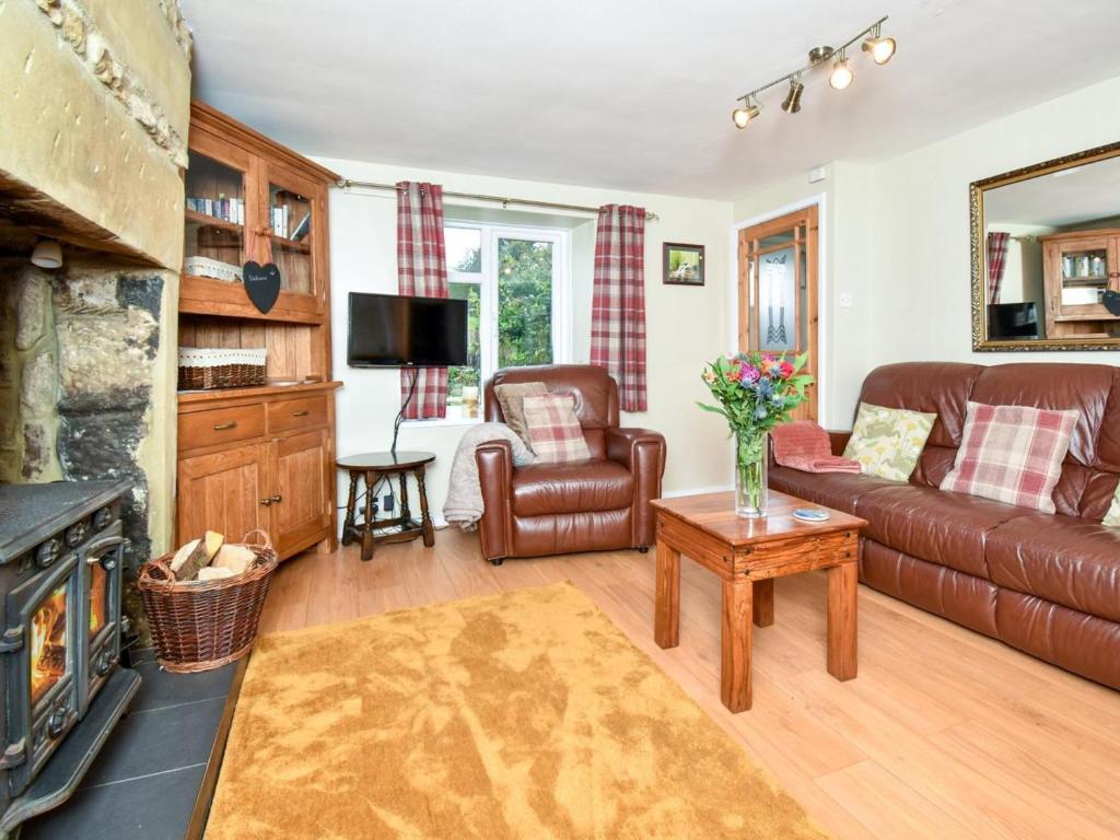 a living room with a couch and a fireplace at 1 Bed in Hexham oc-89085 in Bellingham