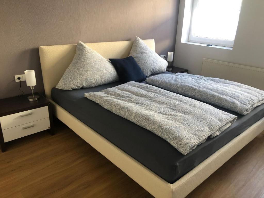 a bed with two pillows on it in a bedroom at Ferienwohnung "Kleiner" EIFELTRAUM in Mettendorf