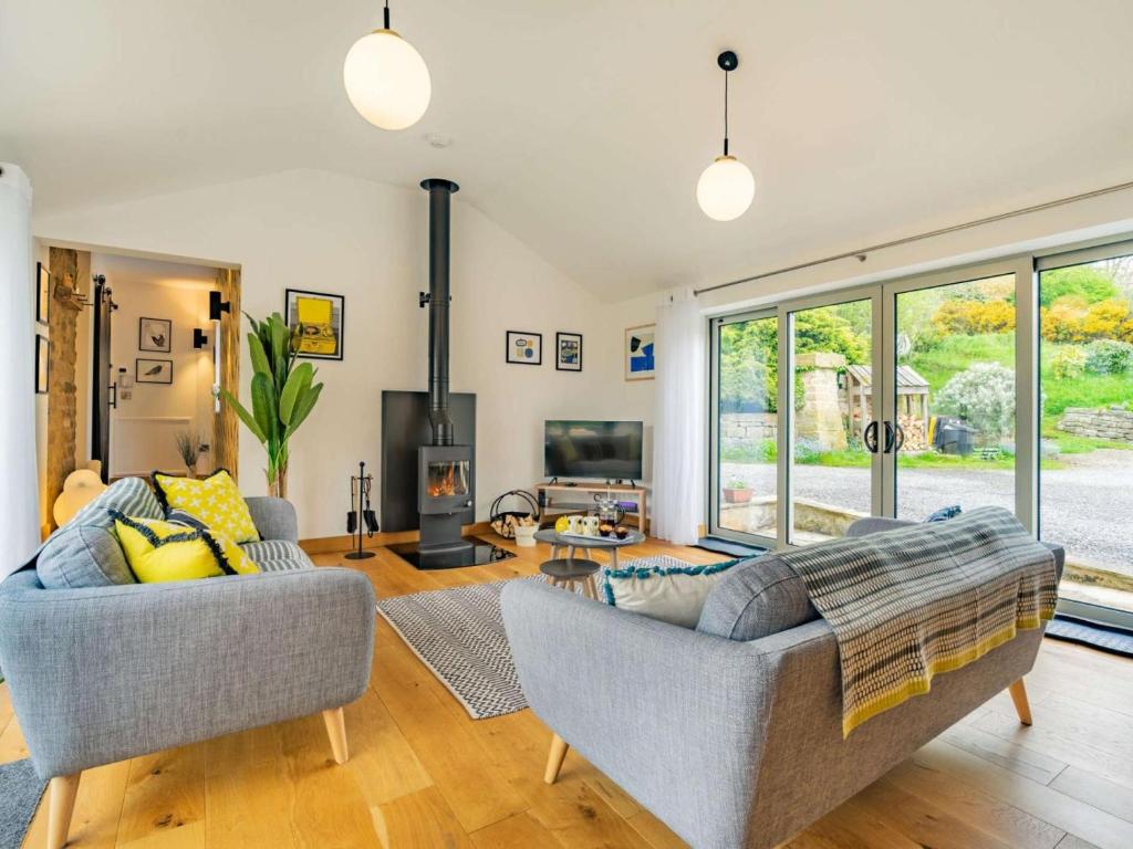 a living room with two couches and a fireplace at 3 Bed in Nr Masham oc-g0149 in Healey