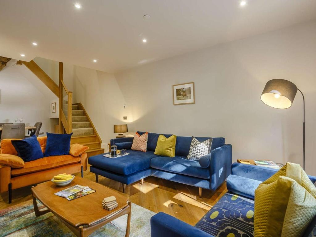 a living room with a blue couch and chairs at 3 Bed in Skipton oc-84014 in Rylstone