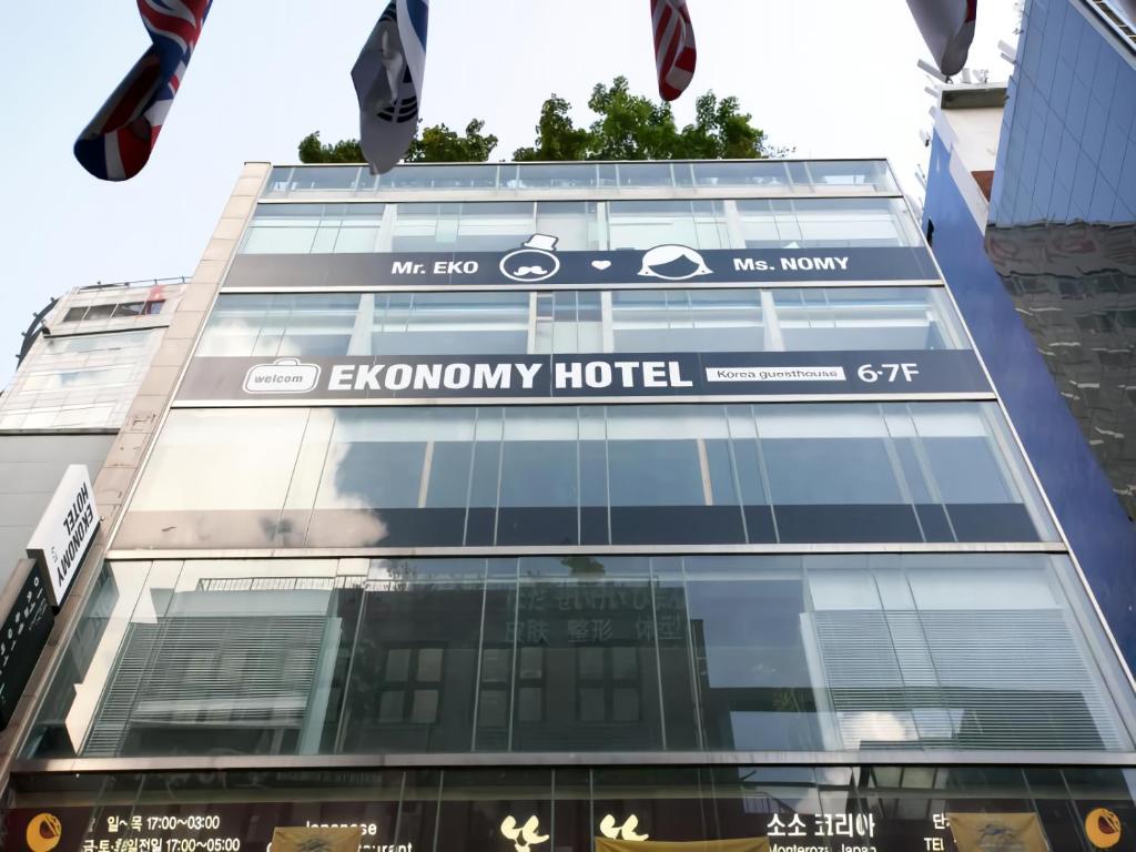 a building with a sign for the economy hotel at Ekonomy Hotel Myeongdong Premier in Seoul