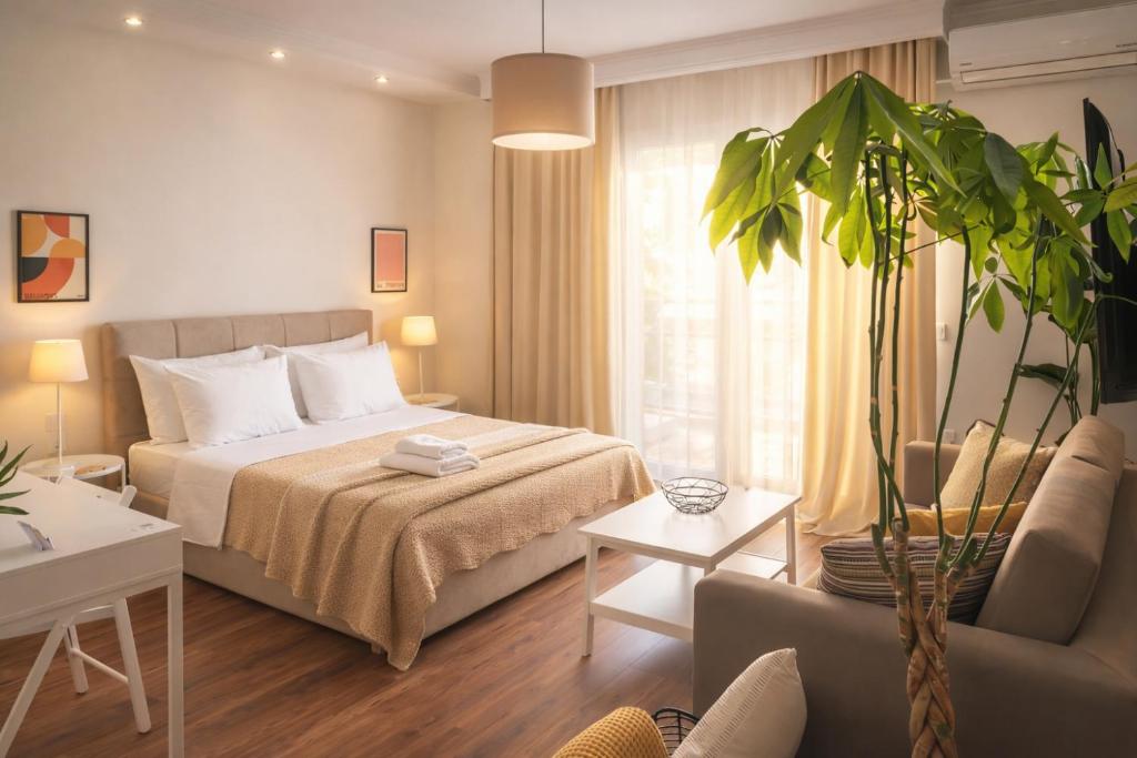 a hotel room with a bed and a plant at Harmony Central Stay with Parking - Meno Homes 6A in Xanthi