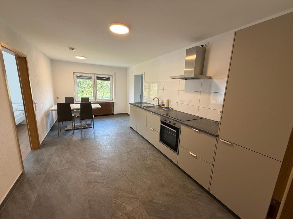 a kitchen with a counter and a table with chairs at Ferienwohnung in Amstetten in Amstetten