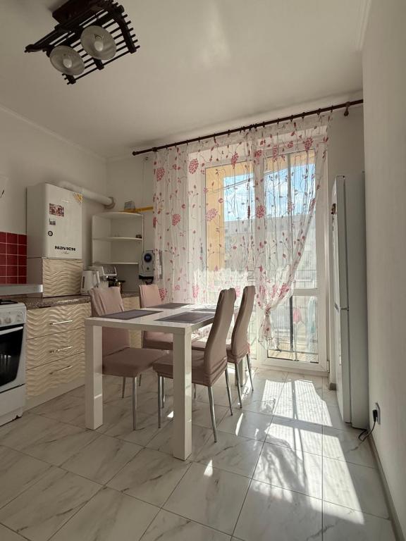 a kitchen with a table and chairs in a room at Apartments Chaiky Kyiv in Chayky