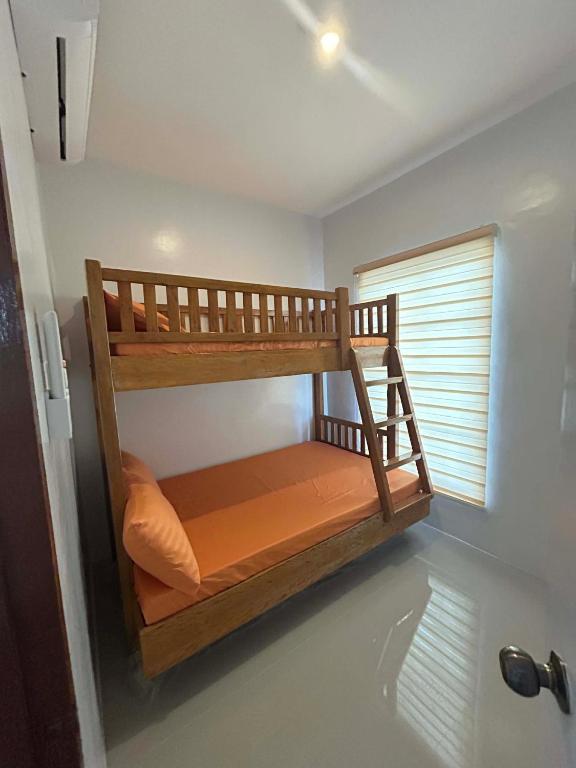 a bunk bed in a room with a window at J20 Building Rental in Calatagan