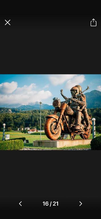 a statue of two people riding a motorcycle at BlueBird Apartments in Latschach