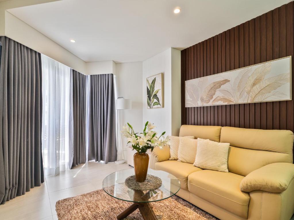 a living room with a couch and a table at Relaxing 1-Bedroom Resort Condo Unit at Tambuli Seaside Living, Mactan, Lapu-lapu City in Maribago