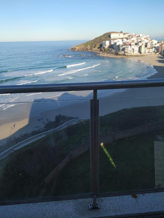 a view of a beach with houses and the ocean at Malpica I in Malpica