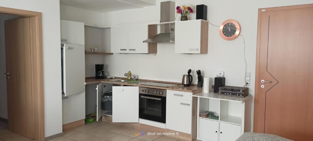 a kitchen with white cabinets and a stove at Ferienwohnung Klaus in Warngau