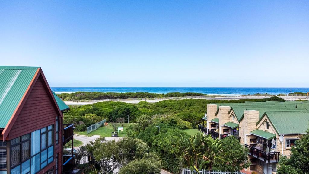 an aerial view of a row of houses and the beach at The Milkwood House in Wilderness