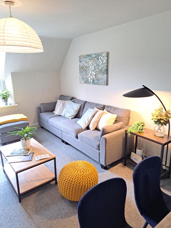 a living room with a couch and a table at Walkers Court By Treetop Property in Cirencester