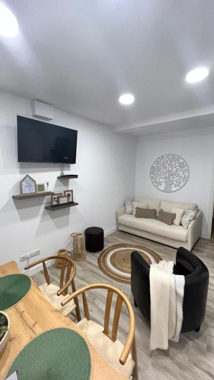 a living room with a couch and a table at Villamadrid Home 2 in Madrid