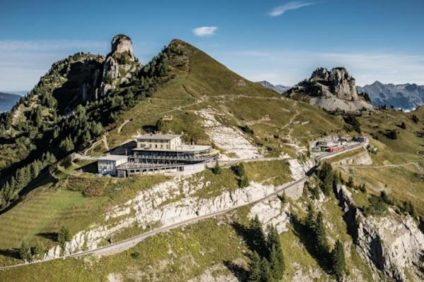 a house on top of a mountain with a road at Hotel Schynige Platte in Wilderswil