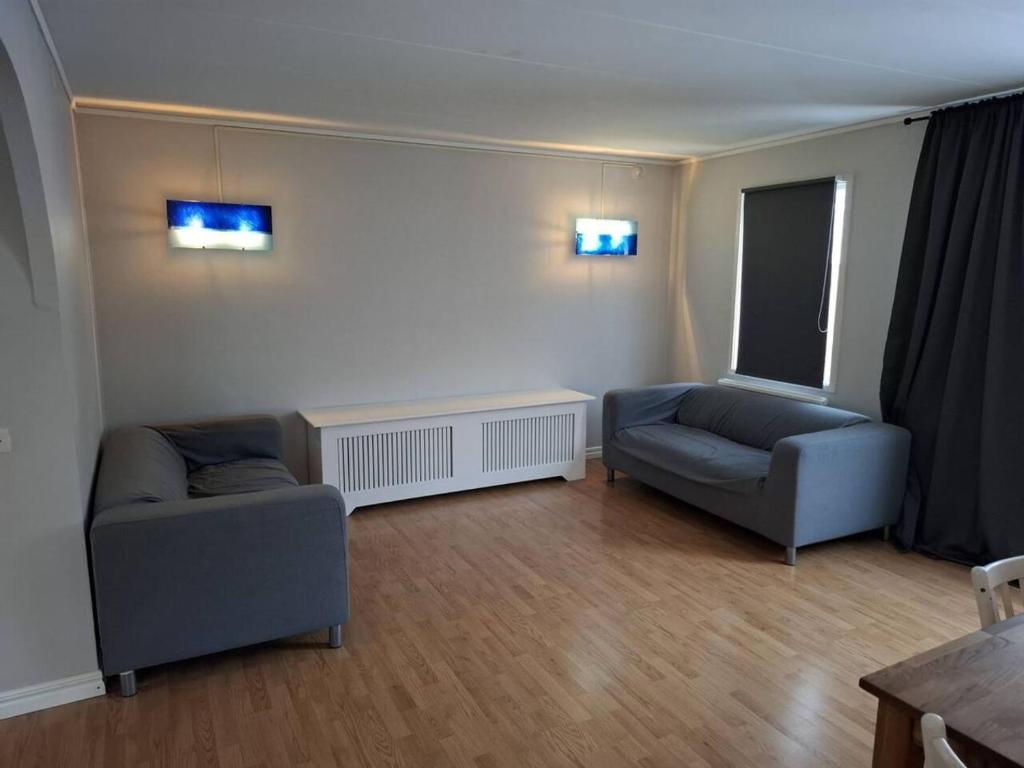 a living room with two chairs and a couch at Workers Stay - Construction Worker Housing in Gothenburg