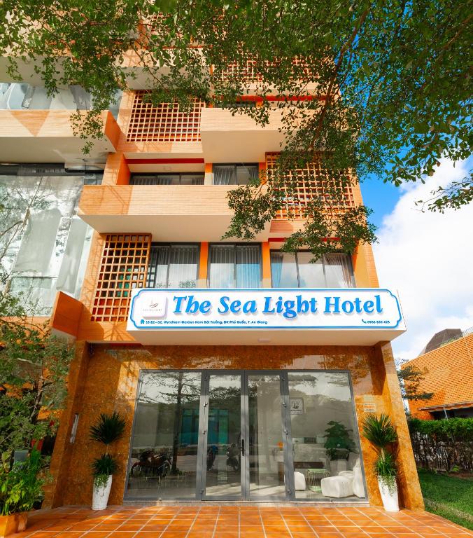a building with a sign for the sea light hotel at The Sea Light Hotel Phú Quốc- Sunset and Ocean View in Phú Quốc