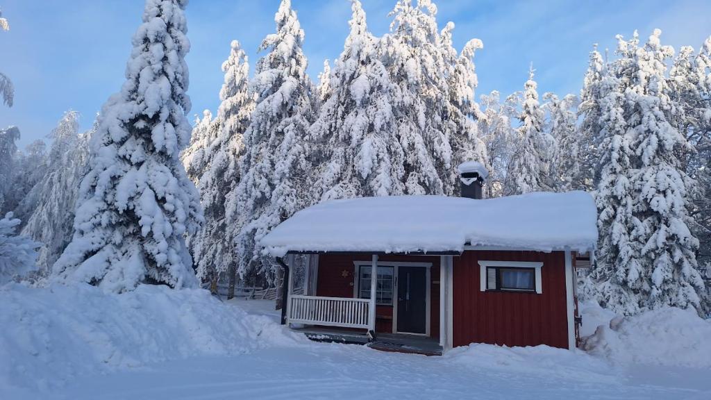a small red cabin with snow on top of it at Villa Lepola Sauna Suite in Rovaniemi