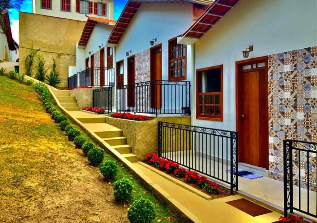 a row of houses with stairs and flowers at Chalé Vila Catarina in Ouro Preto