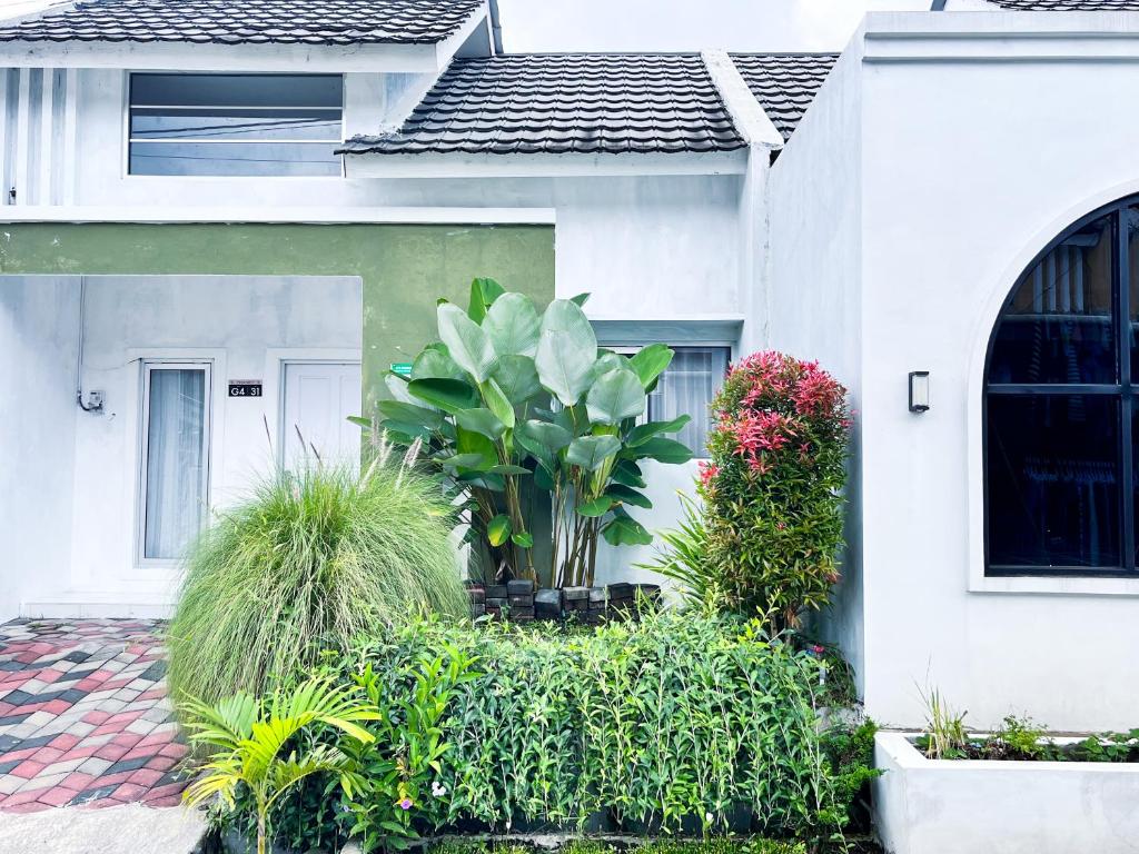a white house with plants in front of it at SleepOver BDI2 in Wonosobo