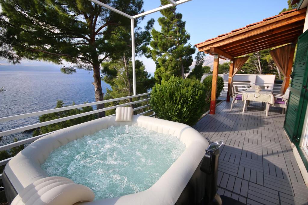 a hot tub on the deck of a house at Brela Beach house in Brela