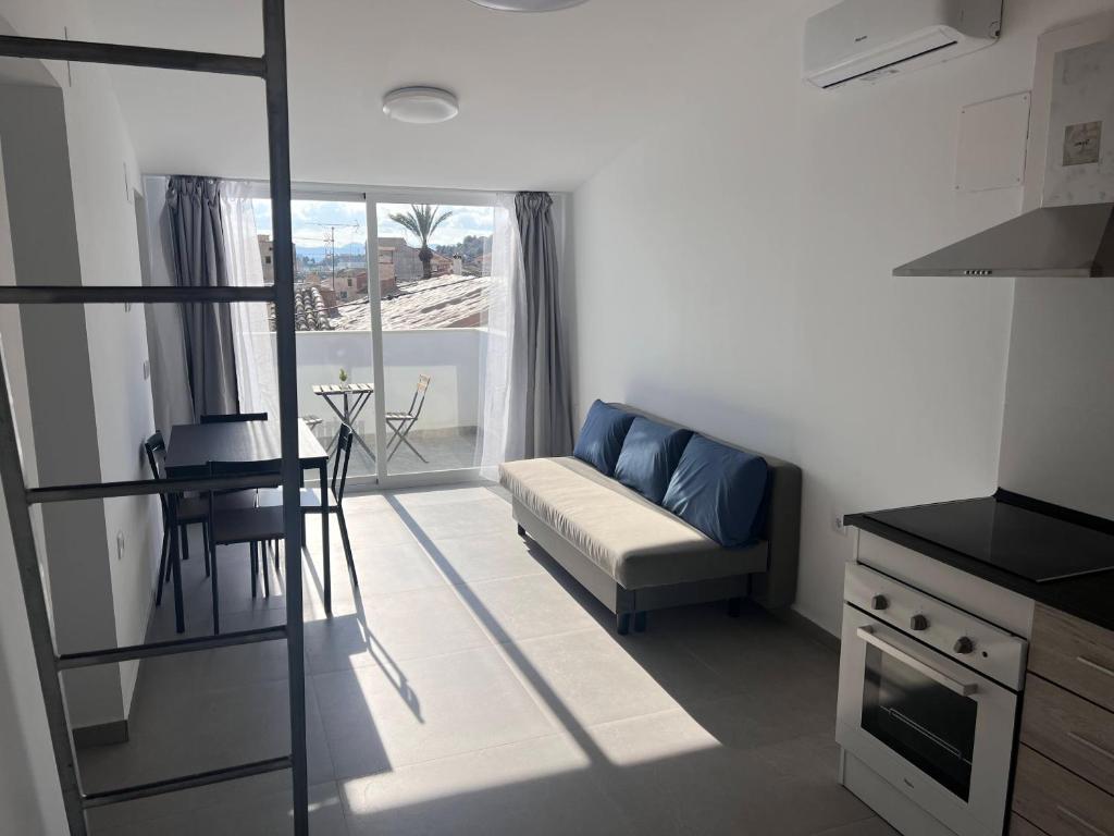 a living room with a couch and a table at Casa Rural Las Vueltas in Mula