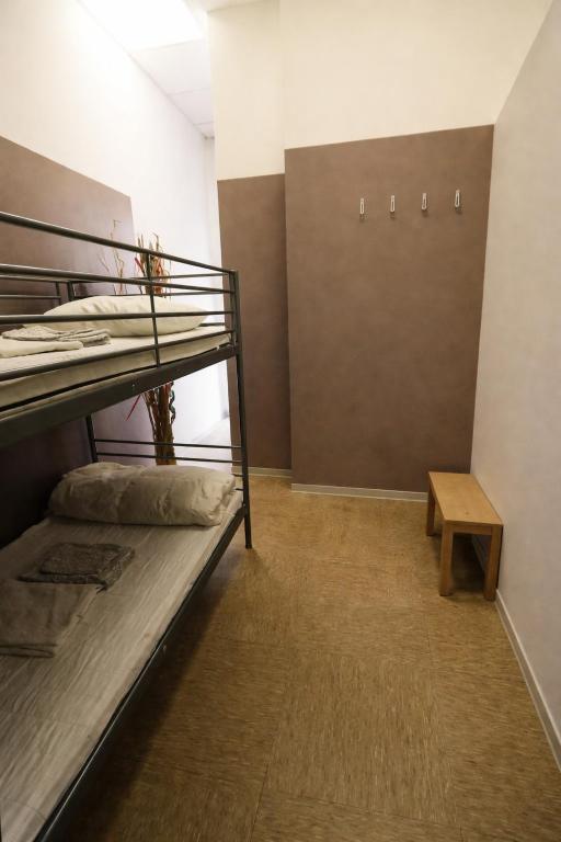 a dorm room with a bunk bed and a table at K-Smart in Catania