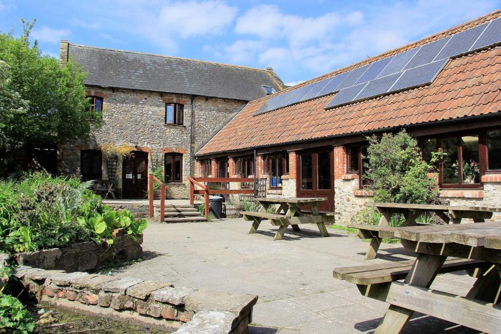 a building with solar panels on the roof at Magdalen The Old Dairy in Winsham