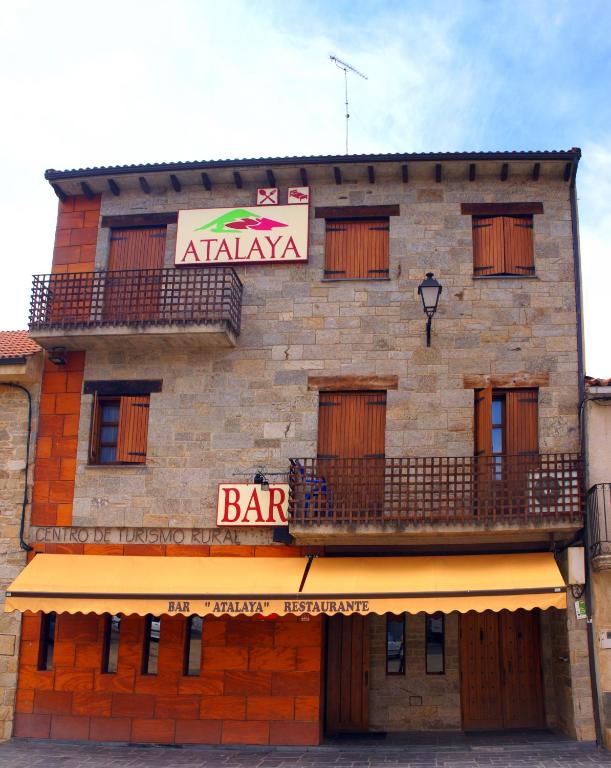 a building with a bar sign on the side of it at hotel rural ATALAYA in Alcañices