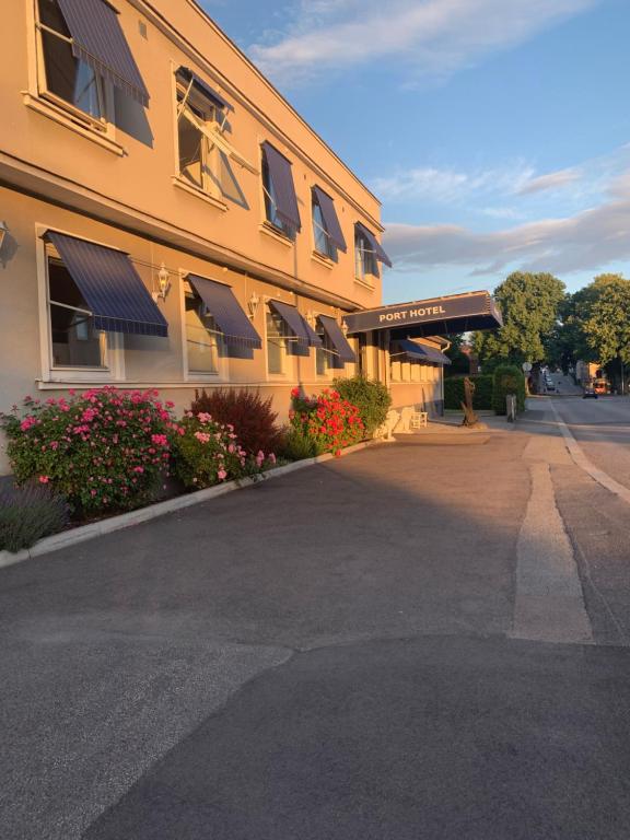 a building with windows and flowers on a street at Port Hotel Apartments in Karlshamn