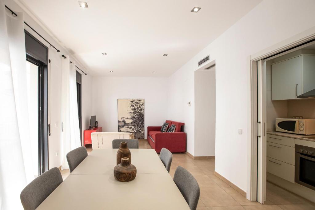 a kitchen and dining room with a table and chairs at Sweet Inas in Sitges