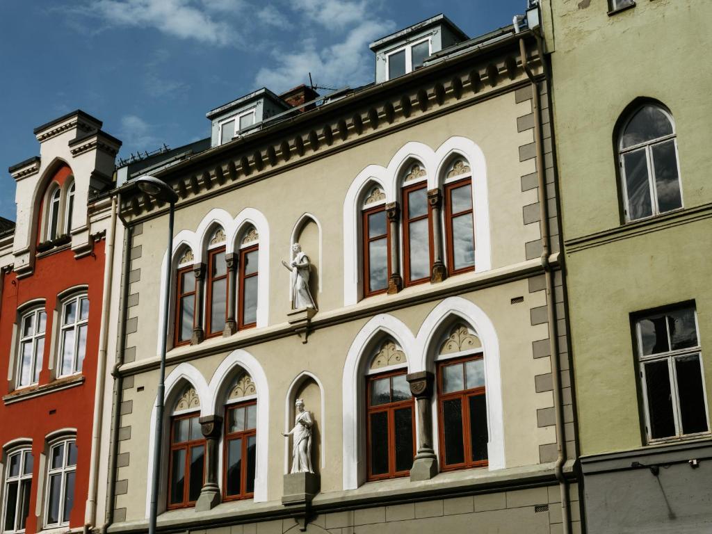 a building with statues on the side of it at Villa Nord in Trondheim