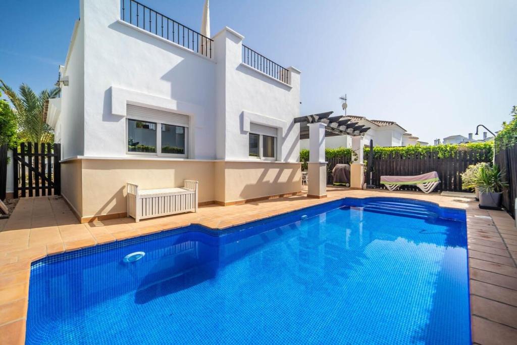 a swimming pool in front of a house at Villa with Private Pool - LO4LT in Torre-Pacheco