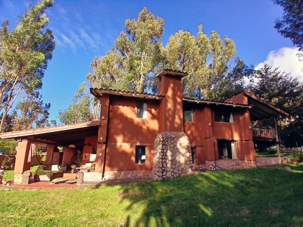 a house in the middle of a field at The Witch's Cottage in Urubamba