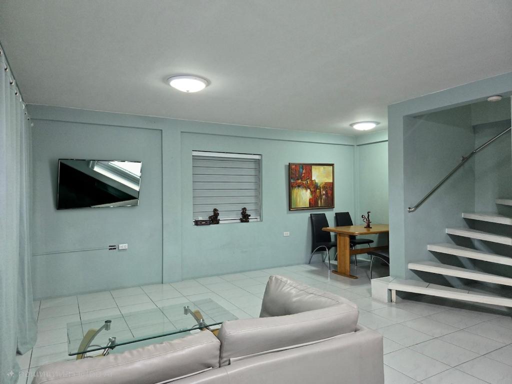 a living room with a couch and a table at Townhome 44 in Ban Nong Pru