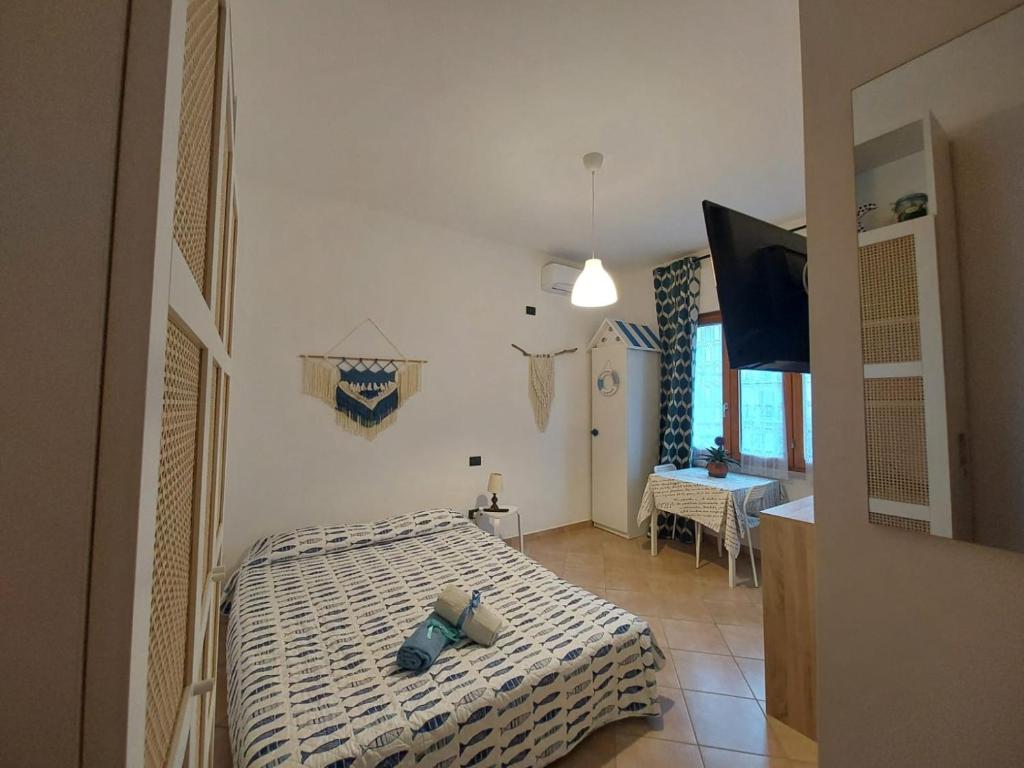 a bedroom with a bed and a television in a room at Amicizia Erminia in Pineto