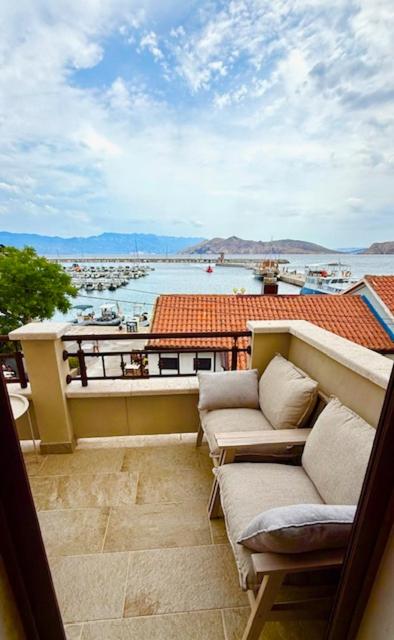 a balcony with couches and a view of a harbor at Family Apartman Baška in Baška