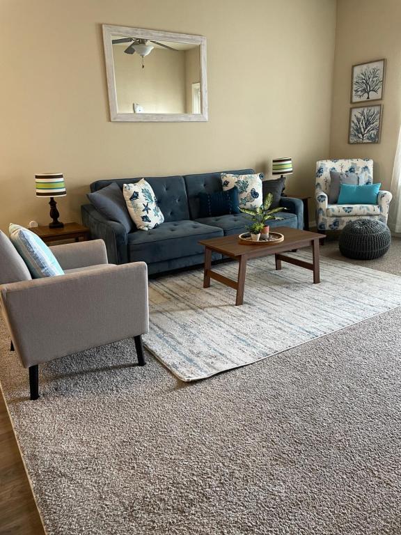 a living room with a blue couch and a table at Coastal Comfort in Jacksonville