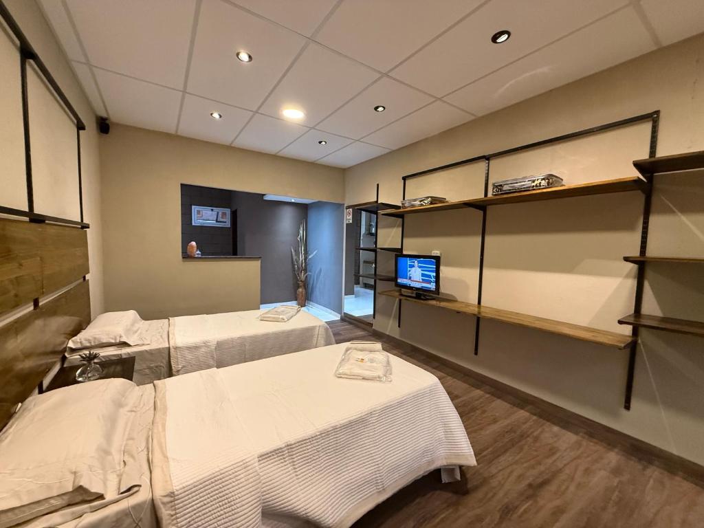 a hospital room with two beds and a tv at Casita de Ceci in Pilar