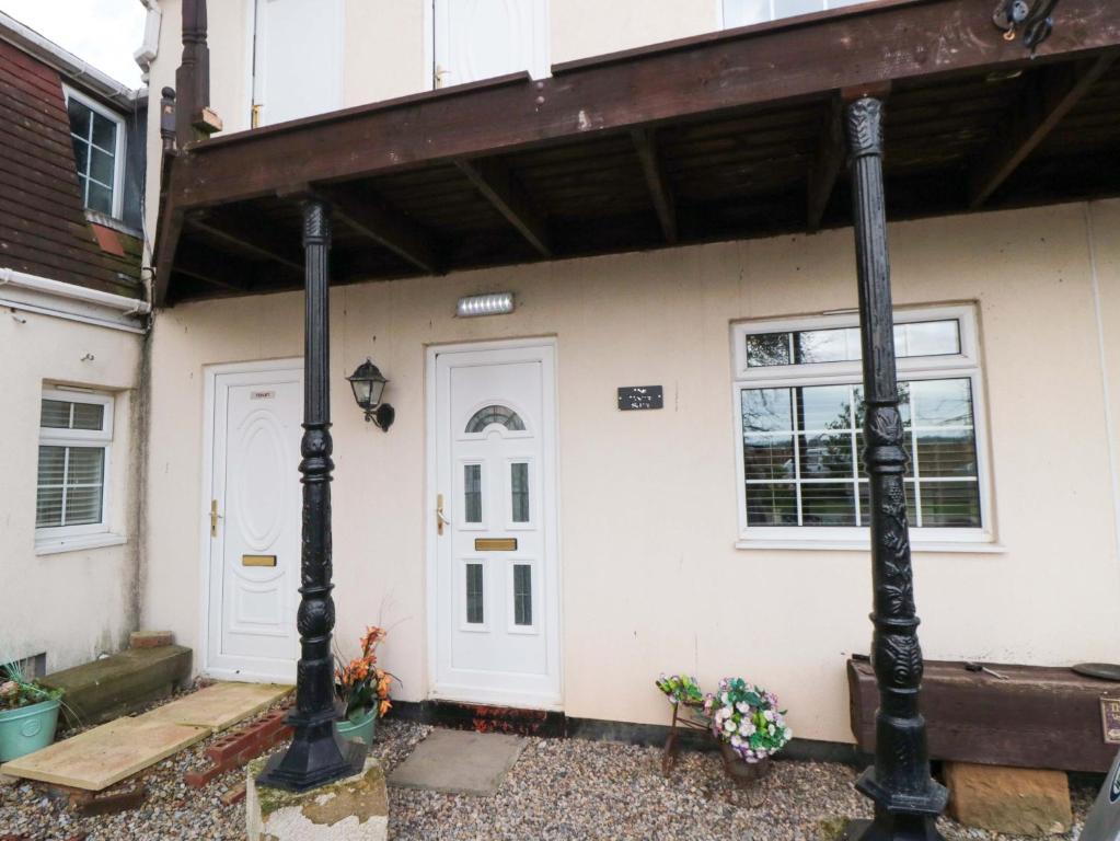 a house with a white door and a porch at Toote Suite in Yarm
