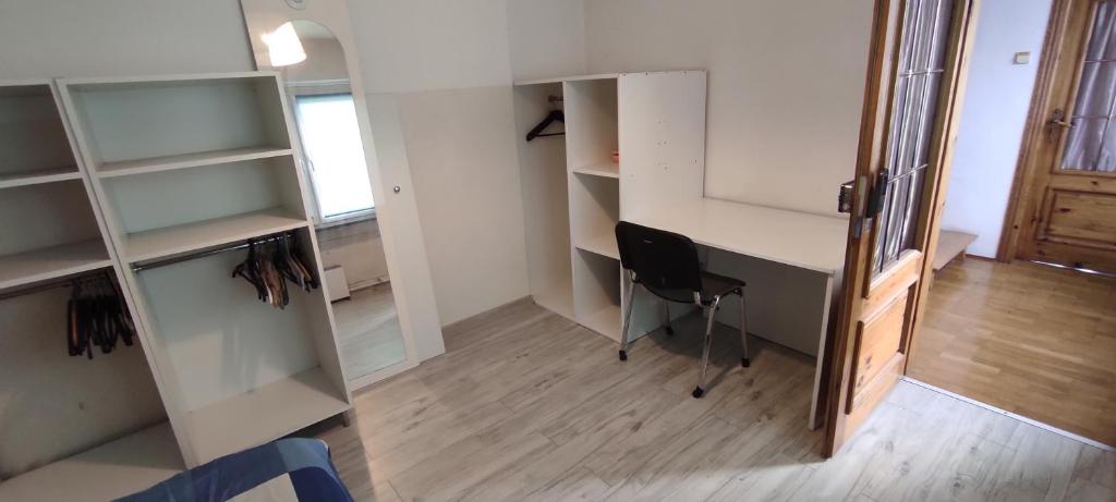 an office with a desk and a chair in a room at Adam room 2 in Wrocław