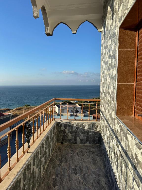 a balcony with a view of the ocean at ZAHA Appart in Ksar es Sghir