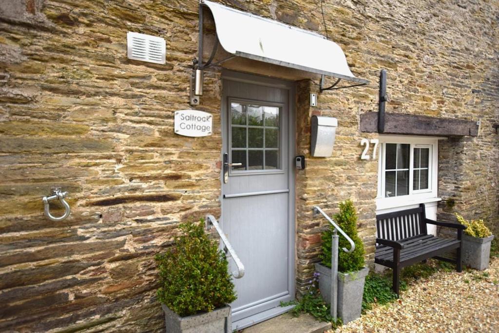 a stone building with a door and a bench at 2 Bed in Kingsbridge oc-bc3188 in Kingsbridge