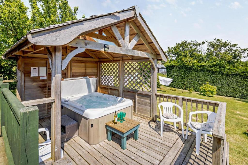 a gazebo with a bath tub on a deck at 2 Bed in Aberystwyth oc-99869 in Devils Bridge