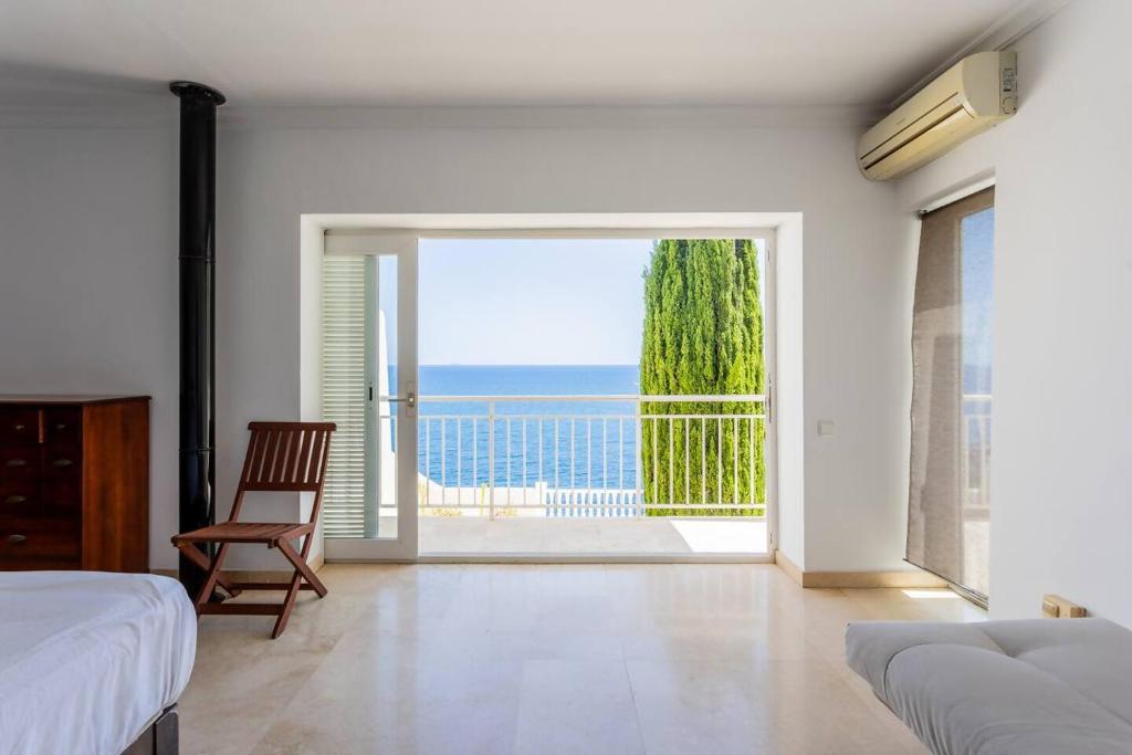 a bedroom with a bed and a view of the ocean at Villa Acantilado Cabo de Palos in Cabo de Palos