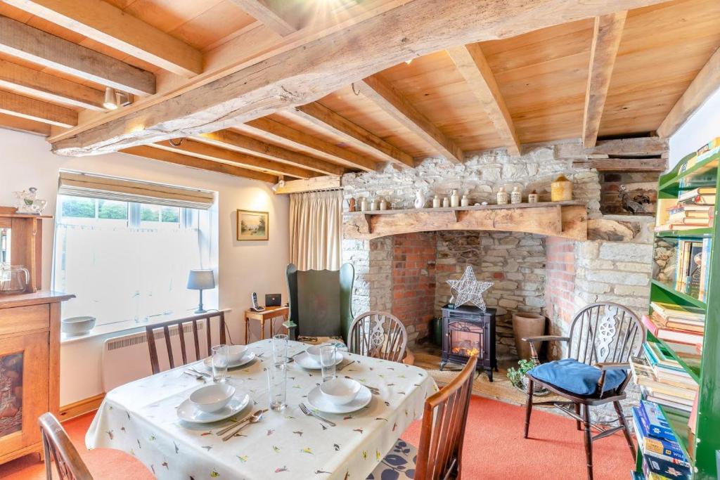 a dining room with a table and a fireplace at 2 Bed in Leintwardine oc-t29563 in Leintwardine