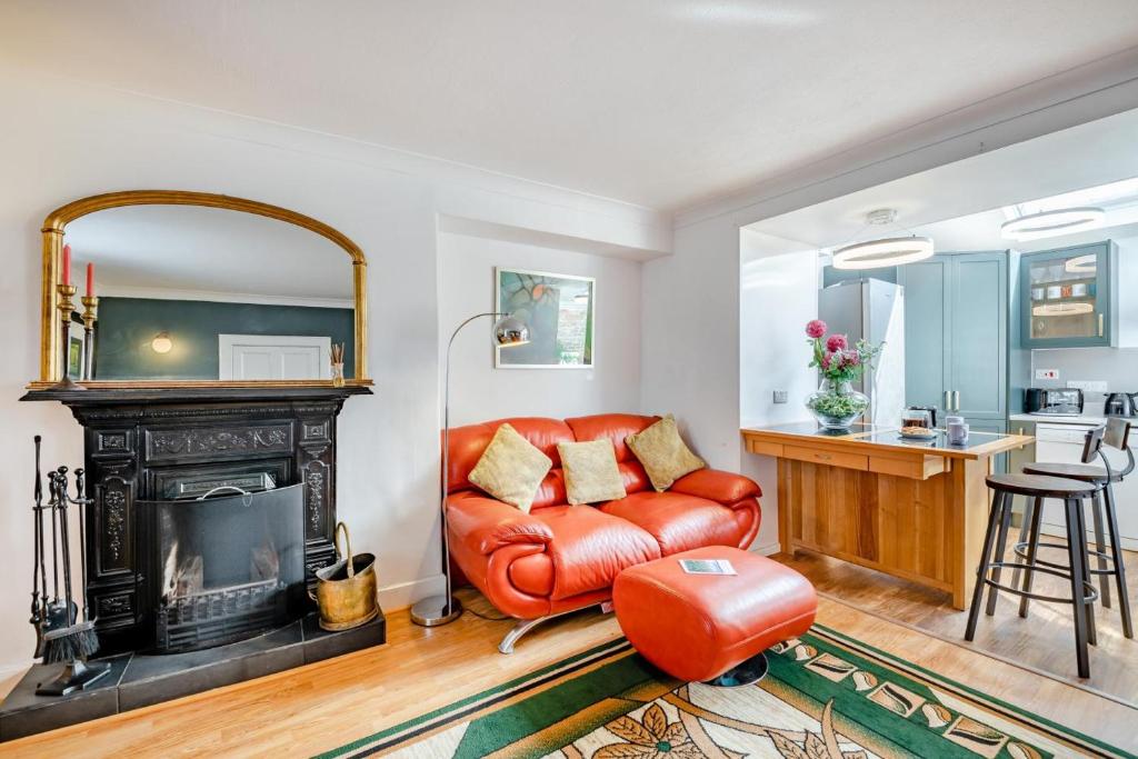 a living room with a red leather couch and a fireplace at 2 Bed in Coldingham oc-c31971 in Coldingham