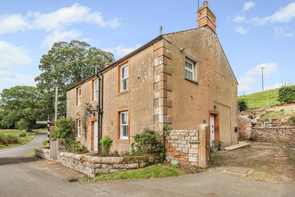 an old brick building on the side of a road at 2 Bed in Staffield oc-j32453 in Kirkoswald