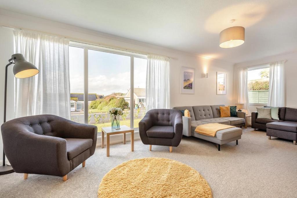 a living room with furniture and a large window at 3 Bed in Croyde oc-f33111 in Croyde