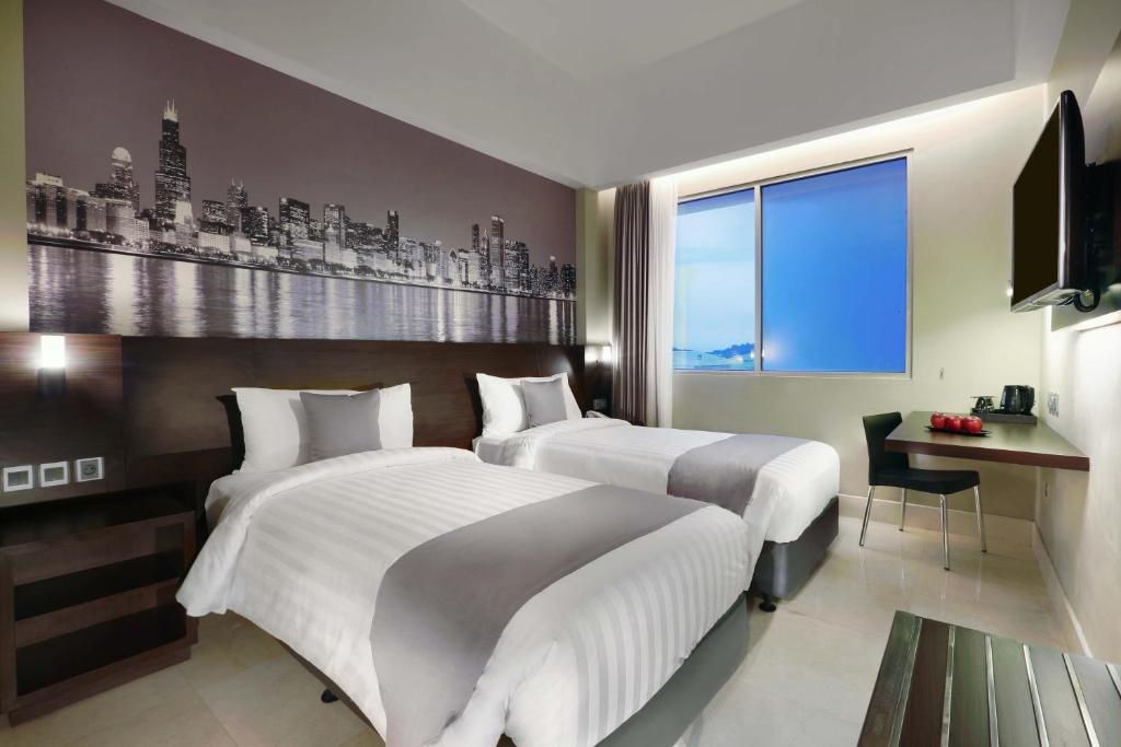Postel nebo postele na pokoji v ubytování Hotel Neo+ Balikpapan by ASTON