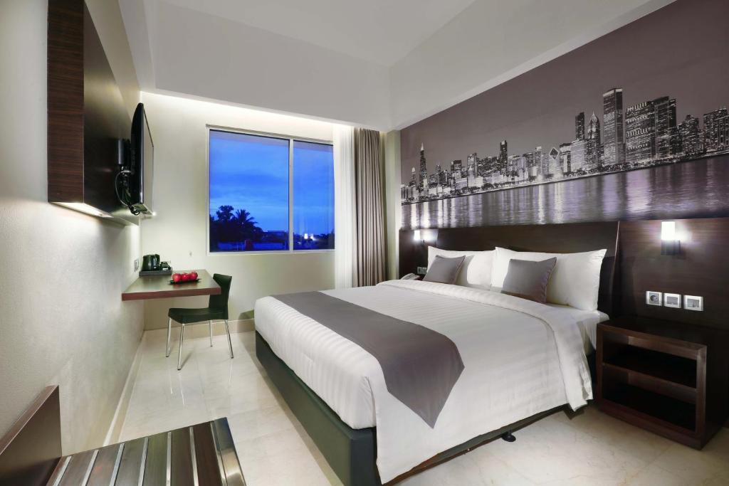 Postel nebo postele na pokoji v ubytování Hotel Neo+ Balikpapan by ASTON