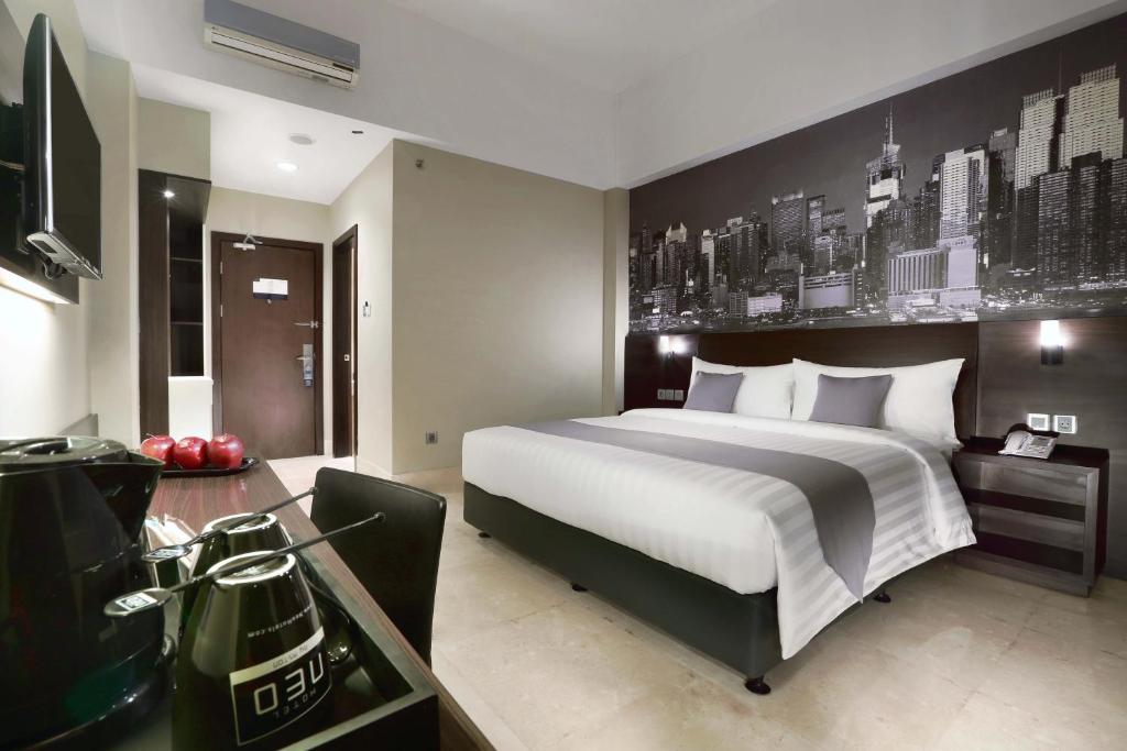 Postel nebo postele na pokoji v ubytování Hotel Neo+ Balikpapan by ASTON